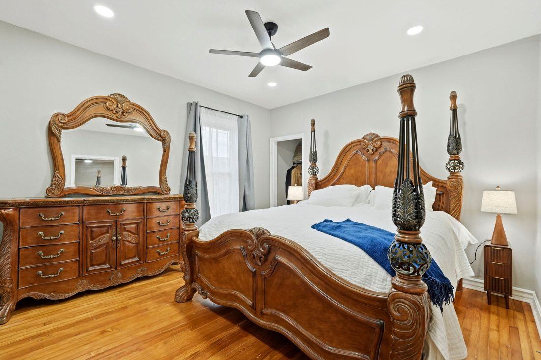 Heiwa: four-poster bed, carved dresser and mirror, ceiling fan